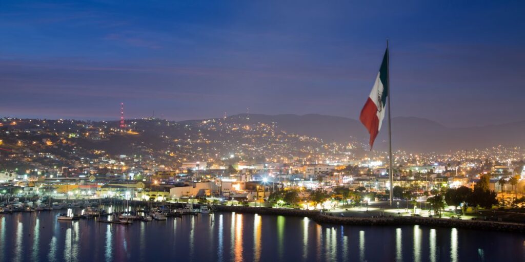 Ensenada, Baja California Mexico at night with Mexican flag shown.