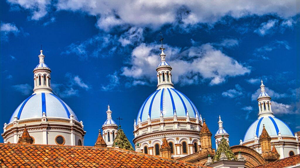 White domes with blue stripes of the La Catedral de la Inmaculada Concepción in Cuenca, Ecuador.