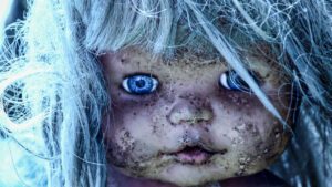 Creepy, dirty blue-eyed blonde doll in Xochimilco, Mexico on the Island of the Dolls.