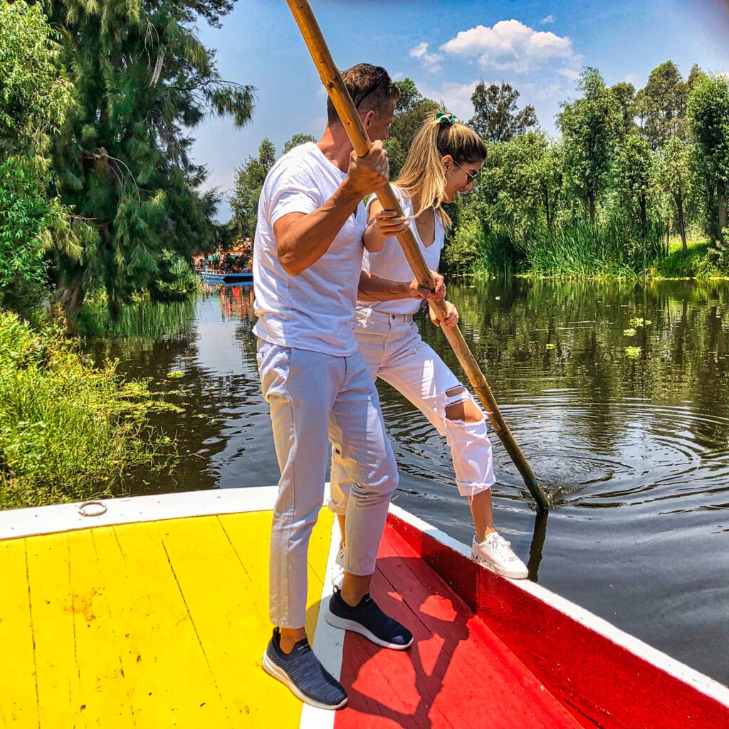Eric and his daughter are pretending to navigate a trajinera in the canals of Xochimilco, Mexico.