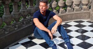 Eric sitting on the black and white checkerboard floor of Chapultepec Castle in Mexico City, Mexico (CDMX).