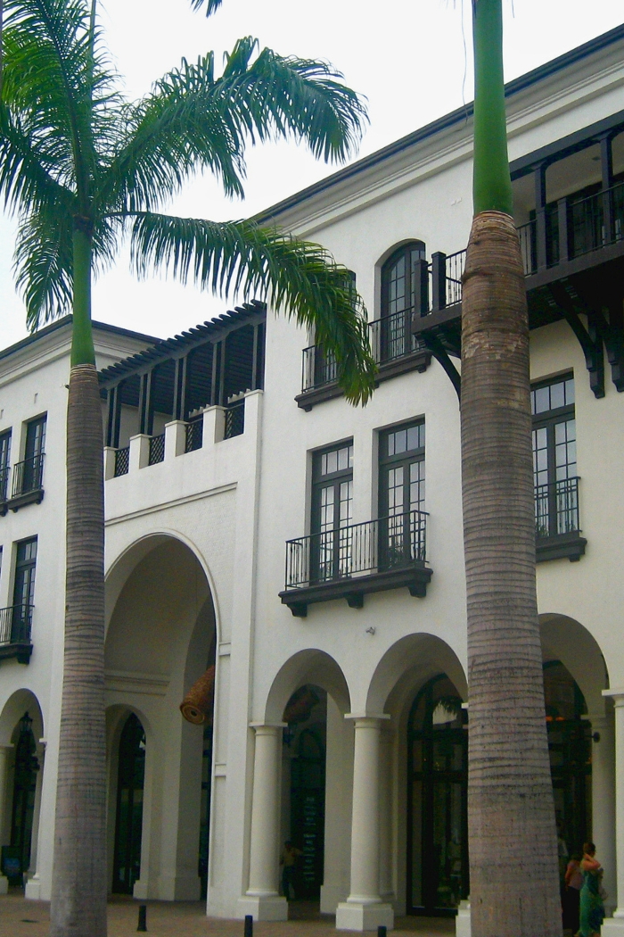 Plaza Lagos Town Center in Samborondón urban area of Guayaquil, Ecuador with groomed palm trees and attractive building.