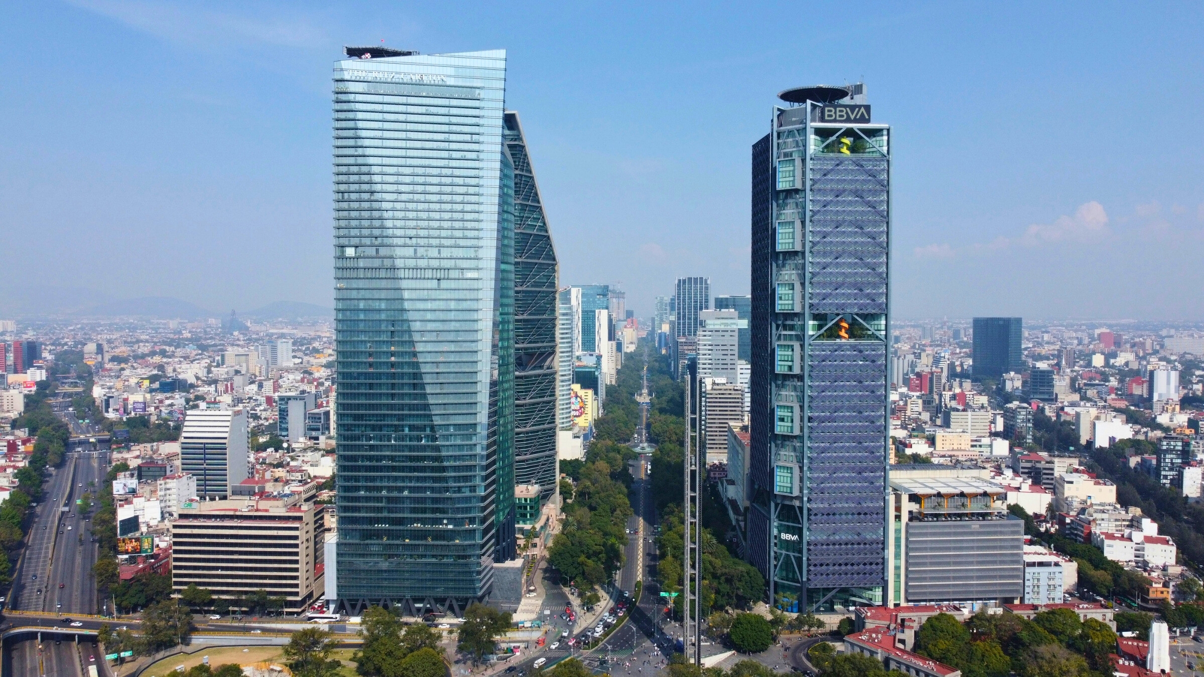 Aerial shot of two imposing skyscrapers on a clear day along Avenida la Reforma in Mexico City, CDMX, Mexico.