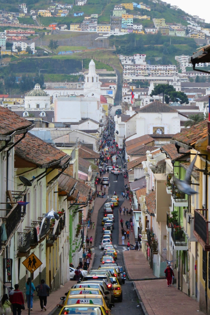 Traffic on a narrow, one way, hilly road with numerous cars and taxis in Quito, Pichincha, one of the best cities to live in Ecuador.