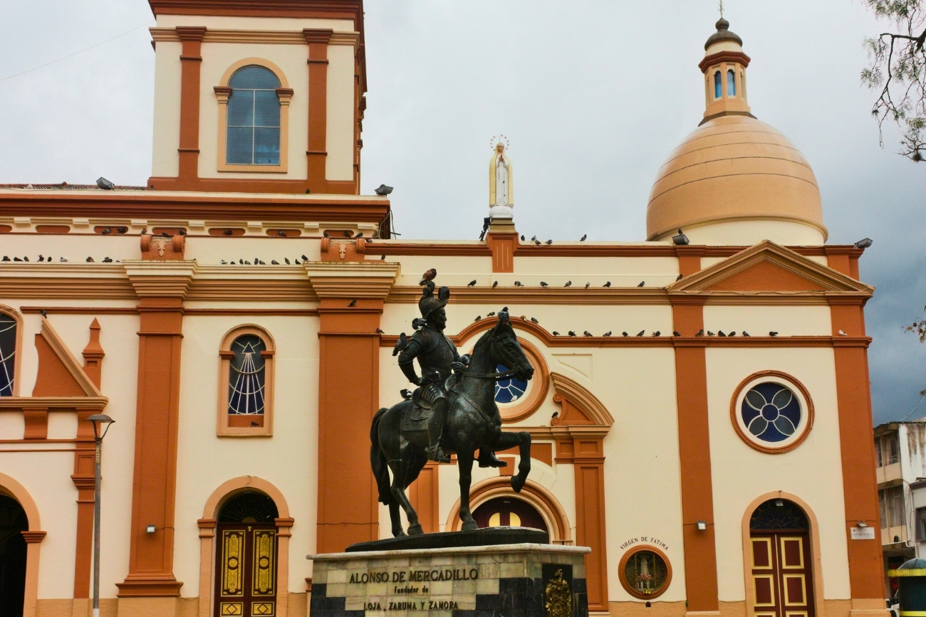 Statue of Alonso de Mercadillo on a horse in Plaza San Francisco in Loja Ecuador on an overcast day.